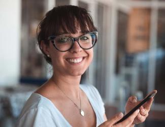 Smiling woman holding a tablet